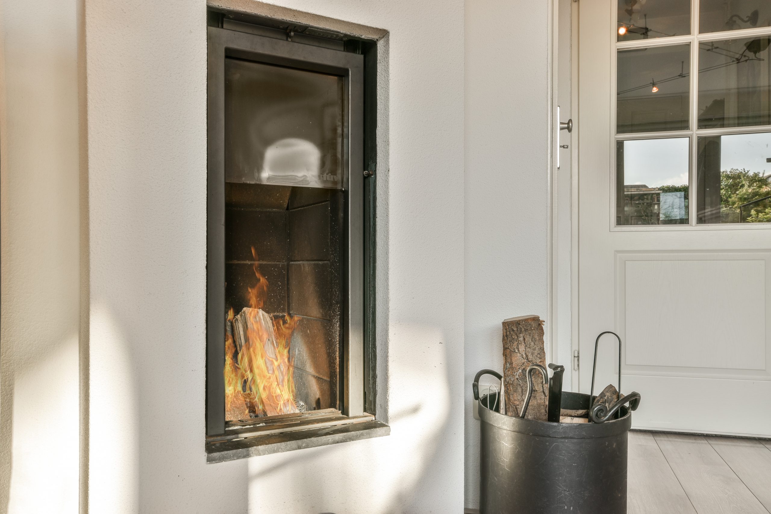 Interior of living room with comfortable sofa and TV against windows in contemporary apartment